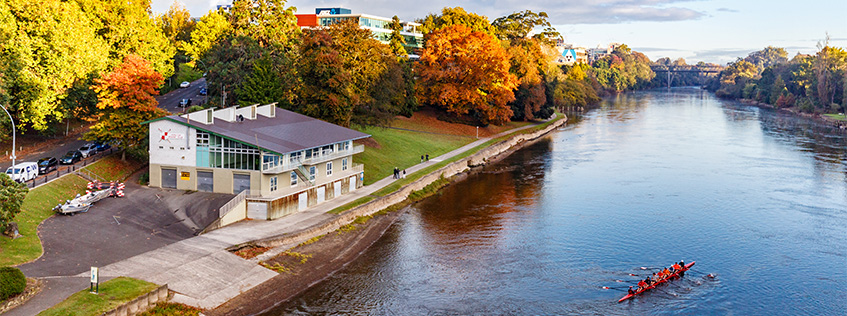 Image of the Waikato River at Grantham street, a canoe is going down the river