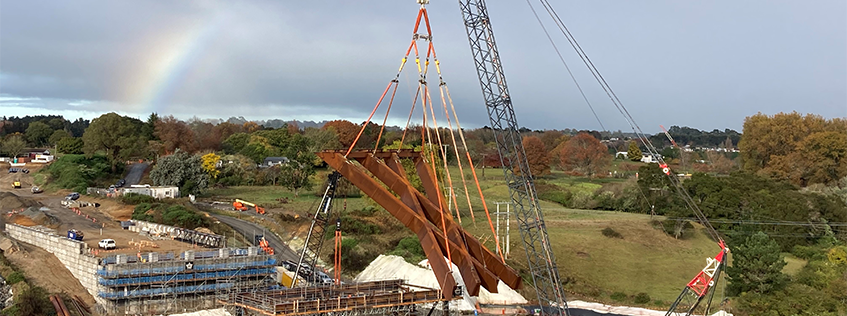 Image of the first of two steel structures being lifted by a crane into place for the new Waikato River bridge in Peacocke