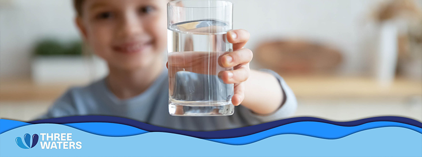 Image of a child holding a glass of water