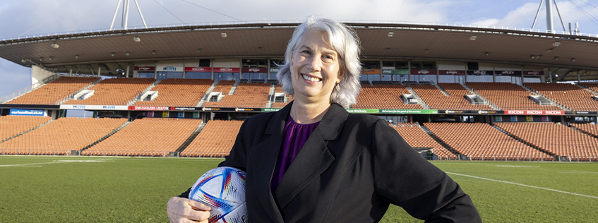 Image of Mayor Southgate holding a football at FMG Stadium Waikato